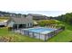 Community pool and clubhouse with a black metal fence surround, set within the neighborhood at 256 Epping Dr, Stockbridge, GA 30281