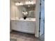 Clean, bright bathroom with double vanity, white cabinets, and well-lit mirror at 256 Epping Drive, Stockbridge, GA 30281