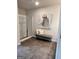 Bright bathroom featuring a glass enclosed shower and a stylish seating area with elegant artwork at 256 Epping Drive, Stockbridge, GA 30281