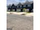 Row of new, modern townhomes with attached garages in a neat community with well-maintained landscaping and a street view at 256 Epping Drive, Stockbridge, GA 30281