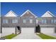 Charming brick townhomes featuring individual garages and manicured lawns under a clear blue sky at 256 Epping Drive, Stockbridge, GA 30281