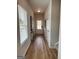 Bright hallway features wood-look floors, modern decor, and a clear view to the front door with natural light coming through the window at 256 Epping Drive, Stockbridge, GA 30281