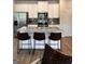 Open kitchen featuring a large island with seating, stainless steel appliances, and modern finishes for a functional and stylish space at 256 Epping Drive, Stockbridge, GA 30281