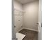 Laundry room featuring neutral walls, tiled floor and wire shelving at 256 Epping Drive, Stockbridge, GA 30281