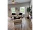 Bright living room with modern decor, comfortable seating, and large windows offering plenty of natural light and wood look flooring at 256 Epping Drive, Stockbridge, GA 30281