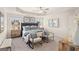Spacious primary bedroom with ceiling fan, lamps, framed art and seating at 256 Epping Drive, Stockbridge, GA 30281