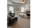 Spacious main bedroom features a ceiling fan, sitting area, and ensuite bathroom at 256 Epping Drive, Stockbridge, GA 30281