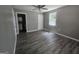 Grey bedroom with wood-look floors, ceiling fan, closet and ensuite bathroom at 367 Frashier Rd, Carrollton, GA 30116