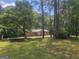 A charming house surrounded by lush green trees in a serene wooded setting at 367 Frashier Rd, Carrollton, GA 30116