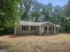 Inviting single-story home featuring a metal roof and covered porch at 367 Frashier Rd, Carrollton, GA 30116