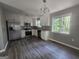 Updated kitchen features stainless steel appliances, white cabinets, granite countertops, and modern flooring at 367 Frashier Rd, Carrollton, GA 30116