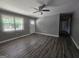 Open living room features new flooring, a ceiling fan, a large window, and freshly painted walls at 367 Frashier Rd, Carrollton, GA 30116