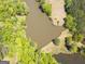 Aerial view showcasing the beautiful lake with surrounding green spaces and mature trees at 637 Lakeview Dr, Newborn, GA 30056