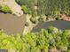 Aerial view of land with lake frontage surrounded by lush greenery and mature trees at 637 Lakeview Dr, Newborn, GA 30056