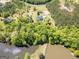 Aerial view of the neighborhood and surrounding area featuring the lake and wooded spaces at 637 Lakeview Dr, Newborn, GA 30056
