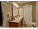 Clean bathroom featuring a wood vanity, white countertop, and modern fixtures for a comfortable and functional space at 637 Lakeview Dr, Newborn, GA 30056