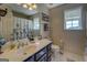 Bright bathroom featuring a vanity with sink, toilet, and natural light from two windows at 637 Lakeview Dr, Newborn, GA 30056