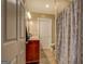Neutral bathroom featuring a cherry vanity, white toilet, and shower with a blue and white paisley shower curtain at 637 Lakeview Dr, Newborn, GA 30056