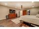 Bedroom featuring wood floors, a ceiling fan, and a large dresser at 637 Lakeview Dr, Newborn, GA 30056