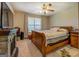 Bedroom with stone fireplace, and a wooden sleigh bed frame with floral accents at 637 Lakeview Dr, Newborn, GA 30056