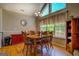 Bright dining room with hardwood floors, six chairs, and natural light from the large window at 637 Lakeview Dr, Newborn, GA 30056
