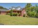 Inviting exterior with brick facade, well-manicured lawn, and mature landscaping, offering great curb appeal and a welcoming ambiance at 637 Lakeview Dr, Newborn, GA 30056