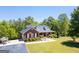 Charming brick home with manicured lawn, mature trees, and a welcoming front porch at 637 Lakeview Dr, Newborn, GA 30056