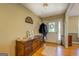A welcoming foyer with wood floors, a dresser, and natural light at 637 Lakeview Dr, Newborn, GA 30056
