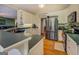 Traditional kitchen features stainless steel appliances, custom white cabinets, and hardwood floors at 637 Lakeview Dr, Newborn, GA 30056