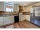 Bright kitchen featuring white cabinets, stainless steel refrigerator, and modern appliances, creating a functional cooking space at 637 Lakeview Dr, Newborn, GA 30056