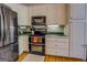 Kitchen with dark appliances, a double oven, wood floors, and plenty of cabinet storage at 637 Lakeview Dr, Newborn, GA 30056
