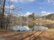 Wide lake view highlighting waterfront property with house in the distance at 637 Lakeview Dr, Newborn, GA 30056