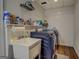 Functional laundry room with sink, shelving, and modern appliances for efficient laundry tasks, includes a washer and dryer at 637 Lakeview Dr, Newborn, GA 30056