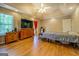 Large main bedroom featuring a ceiling fan, hardwood floors, and a large window at 637 Lakeview Dr, Newborn, GA 30056