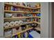 Pantry with wooden shelves filled with food and household supplies at 637 Lakeview Dr, Newborn, GA 30056