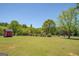 Vast property with lush lawn and mature trees, offering a serene and spacious outdoor environment, has a shed for storage at 637 Lakeview Dr, Newborn, GA 30056