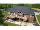 Aerial shot of home's rear, boasting a large deck, patio, and spacious backyard at 637 Lakeview Dr, Newborn, GA 30056