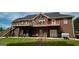 Brick home exterior featuring a spacious deck with an outdoor patio area below it at 637 Lakeview Dr, Newborn, GA 30056