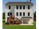 Two-story house with a wooden deck, stairs, and a covered patio in the backyard at 101 Warmstone Path, Peachtree City, GA 30269