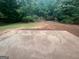 Spacious backyard with mature trees and a concrete patio at 120 Lazy Hollow Ln, Covington, GA 30016