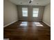 Bright bedroom features hardwood floors, ceiling fan, and two large windows at 120 Lazy Hollow Ln, Covington, GA 30016