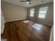 Spacious bedroom with hardwood floors, ceiling fan, and two large windows at 120 Lazy Hollow Ln, Covington, GA 30016