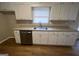 Kitchen featuring granite counters, white cabinets, stainless appliances and wood-look floors at 120 Lazy Hollow Ln, Covington, GA 30016