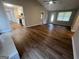 Cozy living room featuring new wood floors, neutral paint, and seamless access to the kitchen at 120 Lazy Hollow Ln, Covington, GA 30016