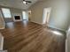 This cozy living room boasts wood floors, a vaulted ceiling with fan, and a classic fireplace at 120 Lazy Hollow Ln, Covington, GA 30016