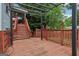 Spacious wooden back deck featuring an overhead pergola and wooden railings and stairs at 1152 Sunday Ln, Jonesboro, GA 30238