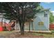 Backyard view of the home showing a wood deck with stairs, a swing, patio, and a large tree at 1152 Sunday Ln, Jonesboro, GA 30238
