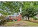 Open backyard with home featuring a wood deck with stairs, concrete patio, and wood privacy fence at 1152 Sunday Ln, Jonesboro, GA 30238