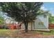 Backyard featuring deck with stairs, large tree, patio, and light-blue vinyl siding at 1152 Sunday Ln, Jonesboro, GA 30238