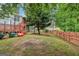 Lush backyard view of the home with wooden deck with stairs, cement patio, and wood privacy fence at 1152 Sunday Ln, Jonesboro, GA 30238
